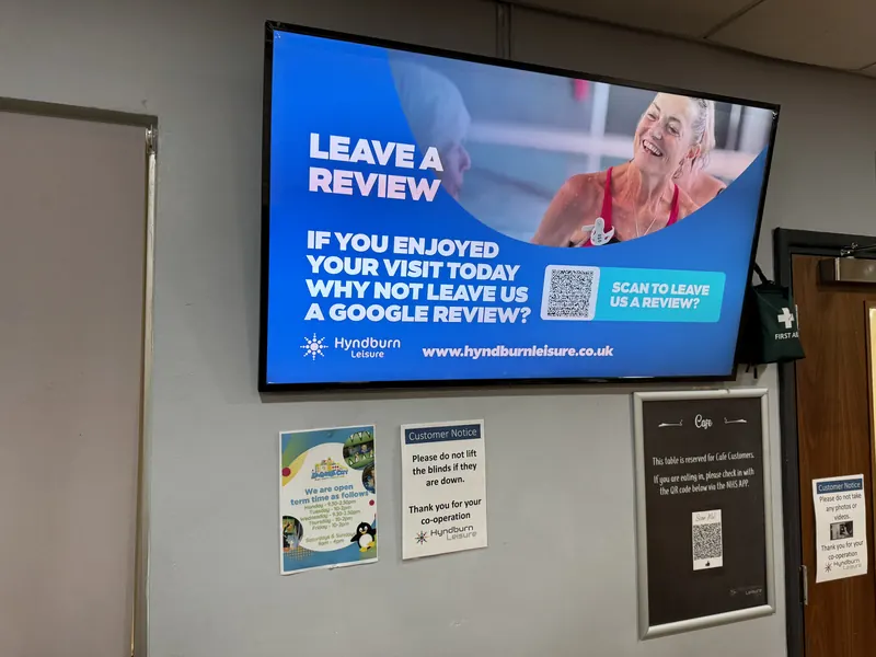 Screen at a Hyndburn Leisure centre asking visitors to leave a Google review
